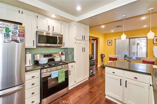 531 Juniper Way, La Habra, CA 90631 - kitchen featuring appliances with stainless steel finishes, dark countertops, dark wood-style floors, decorative backsplash, and recessed lighting