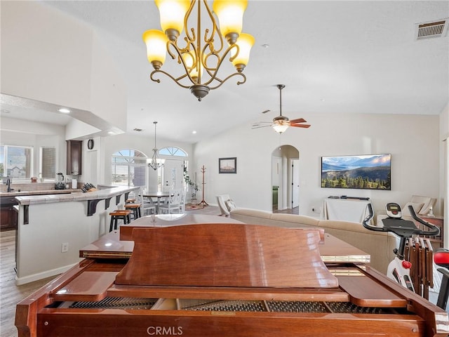 11823 Wintergreen Rd, Pinon Hills, CA 92372 - dining area with a chandelier, arched walkways, lofted ceiling, and ceiling fan