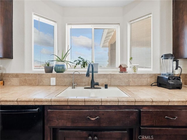11823 Wintergreen Rd, Pinon Hills, CA 92372 - kitchen featuring black dishwasher, dark brown cabinets, light countertops, and plenty of natural light