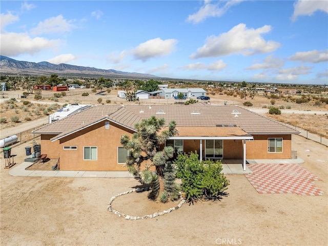 11823 Wintergreen Rd, Pinon Hills, CA 92372 - rear view of house featuring a mountain view, stucco siding, and a tiled roof
