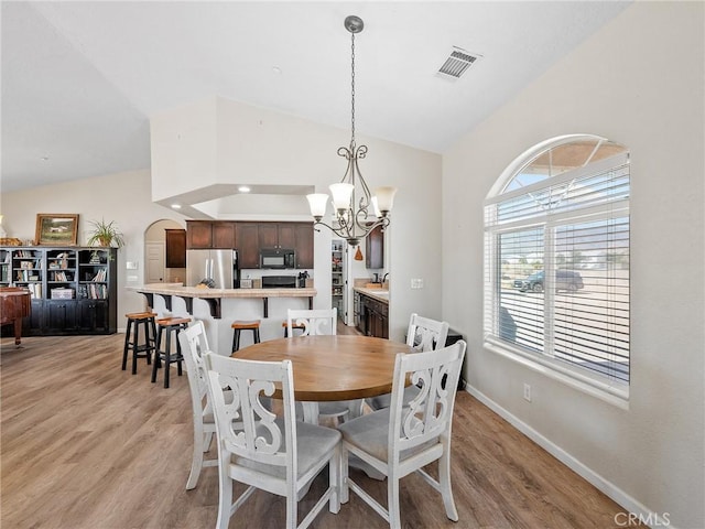 11823 Wintergreen Rd, Pinon Hills, CA 92372 - dining space with a chandelier, light wood-style floors, and high vaulted ceiling