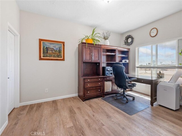11823 Wintergreen Rd, Pinon Hills, CA 92372 - home office featuring light wood-type flooring and baseboards