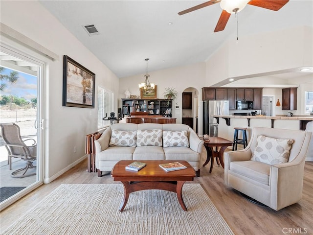 11823 Wintergreen Rd, Pinon Hills, CA 92372 - living area with light wood finished floors, a chandelier, lofted ceiling, healthy amount of natural light, and arched walkways