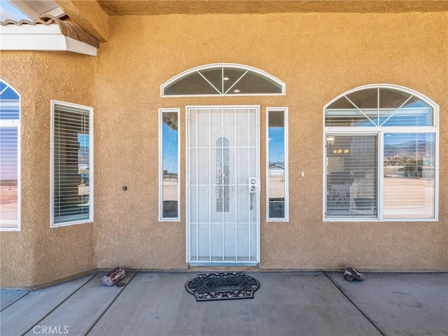11823 Wintergreen Rd, Pinon Hills, CA 92372 - view of exterior entry featuring stucco siding and a patio area