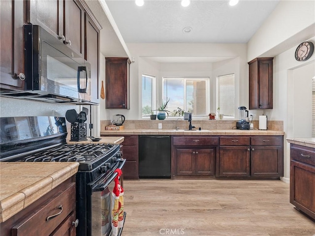 11823 Wintergreen Rd, Pinon Hills, CA 92372 - kitchen featuring black appliances, light wood finished floors, dark brown cabinetry, and recessed lighting