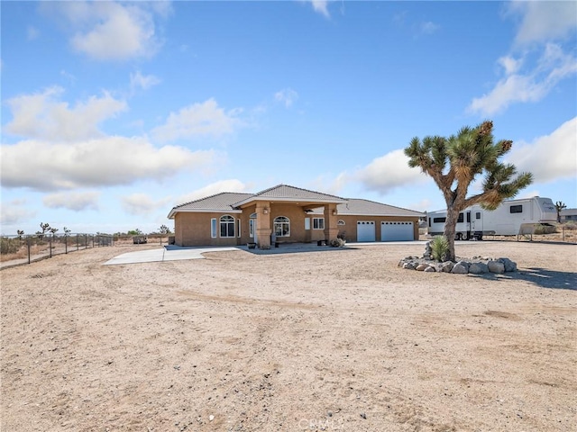 11823 Wintergreen Rd, Pinon Hills, CA 92372 - view of front of property with a garage, driveway, and stucco siding