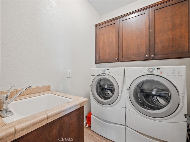 11823 Wintergreen Rd, Pinon Hills, CA 92372 - laundry area featuring cabinet space, separate washer and dryer, and light wood-style floors
