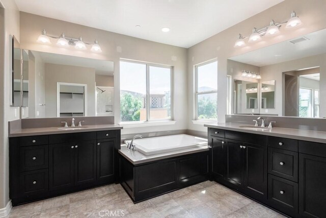 35676 Small Pine Ct, Winchester, CA 92596 - full bath with healthy amount of natural light, two vanities, and a bath