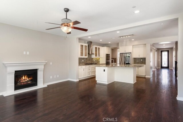 35676 Small Pine Ct, Winchester, CA 92596 - unfurnished living room featuring a ceiling fan, a glass covered fireplace, dark wood finished floors, and recessed lighting