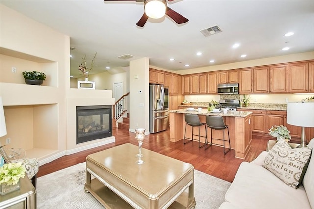 1180 Cornwell Dr, Fullerton, CA 92833 - living area featuring wood finished floors, ceiling fan, a multi sided fireplace, and recessed lighting