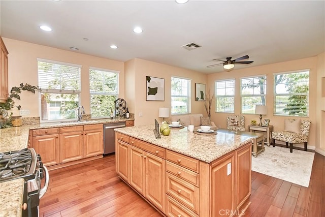 1180 Cornwell Dr, Fullerton, CA 92833 - kitchen with stainless steel appliances, light wood finished floors, light stone counters, a kitchen island, and a ceiling fan