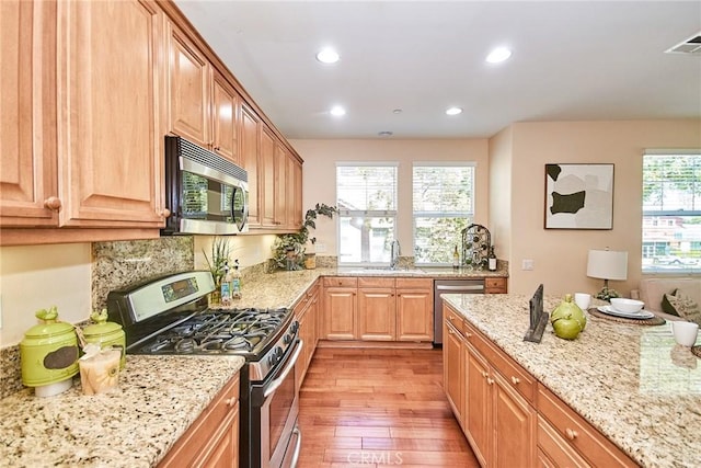 1180 Cornwell Dr, Fullerton, CA 92833 - kitchen with stainless steel appliances, light wood-style floors, light stone countertops, and recessed lighting