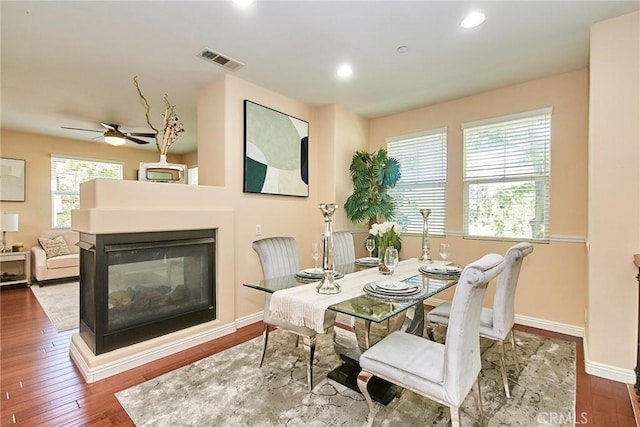 1180 Cornwell Dr, Fullerton, CA 92833 - dining room featuring a multi sided fireplace, hardwood / wood-style floors, recessed lighting, and a ceiling fan