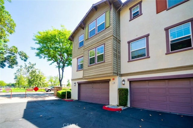 1180 Cornwell Dr, Fullerton, CA 92833 - rear view of house with stucco siding and a garage
