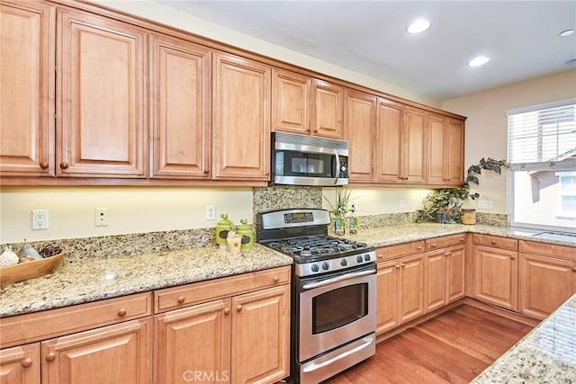 1180 Cornwell Dr, Fullerton, CA 92833 - kitchen with stainless steel appliances, light wood-style floors, light stone countertops, and recessed lighting