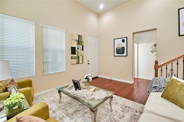 1180 Cornwell Dr, Fullerton, CA 92833 - living room featuring wood finished floors, a high ceiling, stairs, and recessed lighting