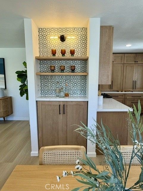 11117 Maidstone Ave, Norwalk, CA 90650 - bar area featuring baseboards and light wood-style flooring