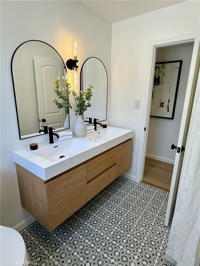 11117 Maidstone Ave, Norwalk, CA 90650 - full bathroom with double vanity and toilet