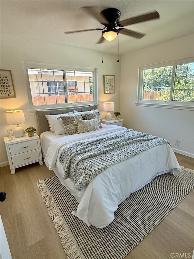 11117 Maidstone Ave, Norwalk, CA 90650 - bedroom with multiple windows, wood finished floors, and a ceiling fan