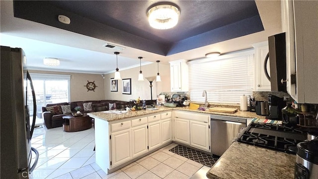 8467 Penfield Ave, Winnetka, CA 91306 - kitchen featuring appliances with stainless steel finishes, open floor plan, a peninsula, light tile patterned floors, and white cabinets