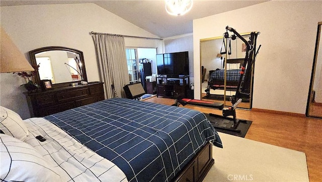 8467 Penfield Ave, Winnetka, CA 91306 - bedroom featuring vaulted ceiling and wood finished floors