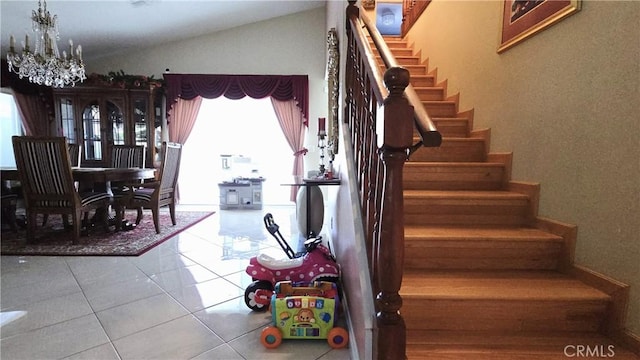 8467 Penfield Ave, Winnetka, CA 91306 - staircase with tile patterned flooring, lofted ceiling, and a chandelier