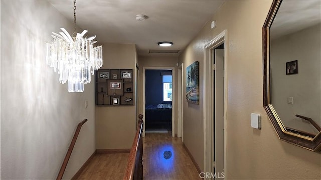 8467 Penfield Ave, Winnetka, CA 91306 - corridor with wood finished floors and a chandelier