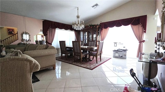 8467 Penfield Ave, Winnetka, CA 91306 - dining room featuring a chandelier, lofted ceiling, and light tile patterned flooring
