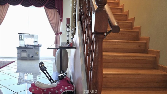 8467 Penfield Ave, Winnetka, CA 91306 - stairway featuring plenty of natural light and tile patterned floors