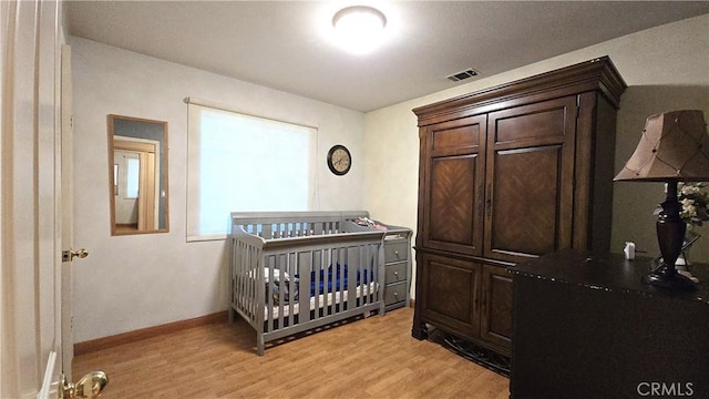 8467 Penfield Ave, Winnetka, CA 91306 - bedroom with light wood finished floors and a nursery area
