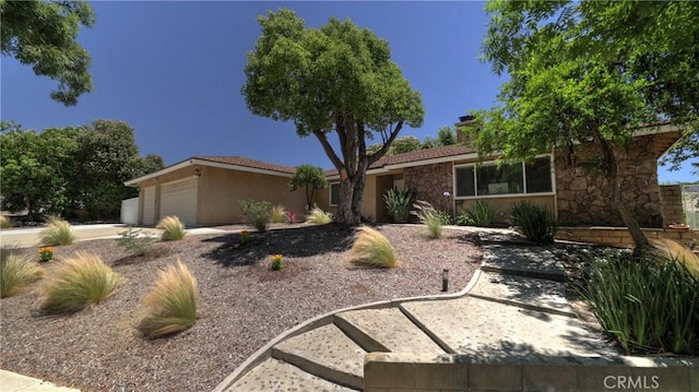 108 Limestone Rd, Claremont, CA 91711 - ranch-style house featuring an attached garage, stone siding, stucco siding, and driveway