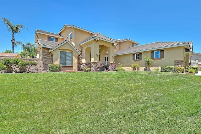 14182 Whitebark Ave, Chino, CA 91710 - view of front of home featuring stucco siding, a front yard, and stone siding
