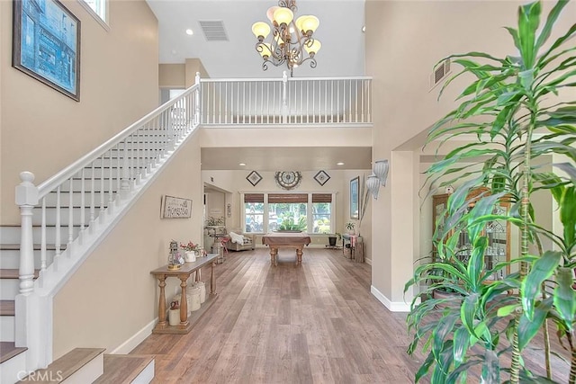 14182 Whitebark Ave, Chino, CA 91710 - entrance foyer with a high ceiling, stairs, wood finished floors, billiards, and a chandelier