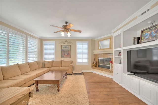 14182 Whitebark Ave, Chino, CA 91710 - living room featuring crown molding, ceiling fan, light wood finished floors, and a glass covered fireplace