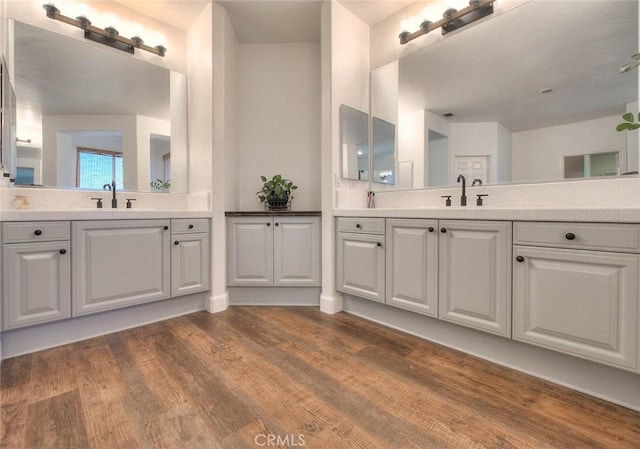 14182 Whitebark Ave, Chino, CA 91710 - full bathroom featuring two vanities and wood finished floors