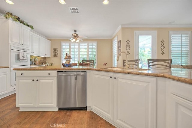 14182 Whitebark Ave, Chino, CA 91710 - kitchen with stainless steel dishwasher, ceiling fan, crown molding, recessed lighting, and light wood-style flooring