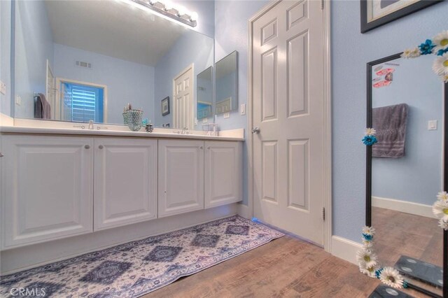 14182 Whitebark Ave, Chino, CA 91710 - full bathroom with double vanity and wood finished floors
