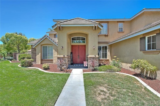 14182 Whitebark Ave, Chino, CA 91710 - view of front of house with stucco siding, a front lawn, and stone siding