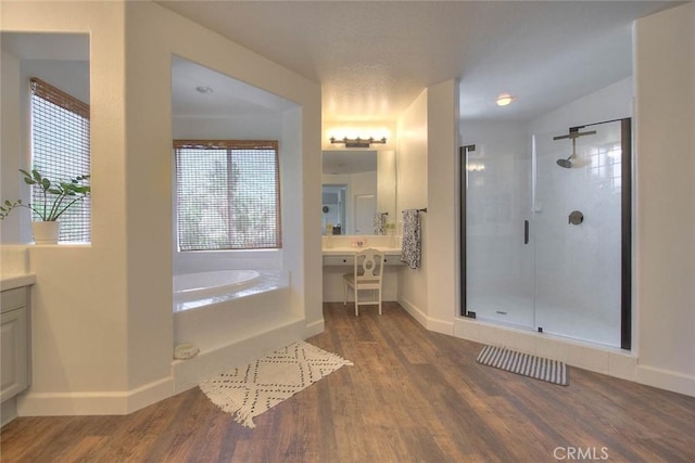 14182 Whitebark Ave, Chino, CA 91710 - bathroom with a shower stall, a bath, and wood finished floors