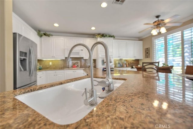 14182 Whitebark Ave, Chino, CA 91710 - kitchen with stainless steel fridge, white cabinets, a ceiling fan, light stone countertops, and recessed lighting