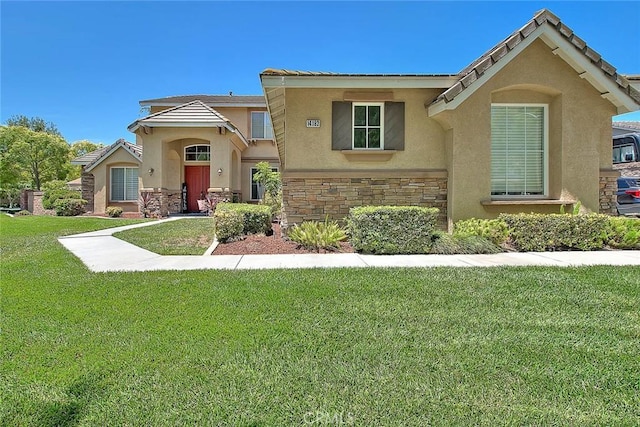 14182 Whitebark Ave, Chino, CA 91710 - view of front of property featuring stucco siding, stone siding, and a front lawn