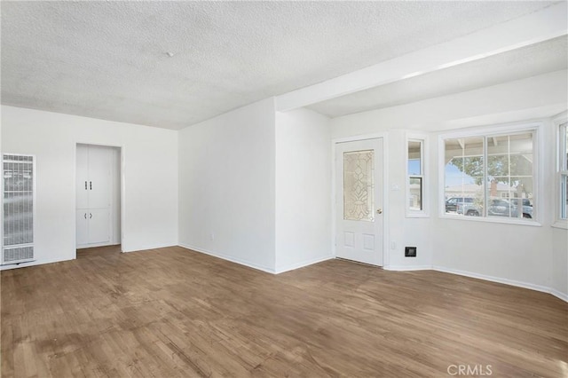 2210 W 7th St, Santa Ana, CA 92703 - unfurnished room with a heating unit, wood finished floors, and a textured ceiling