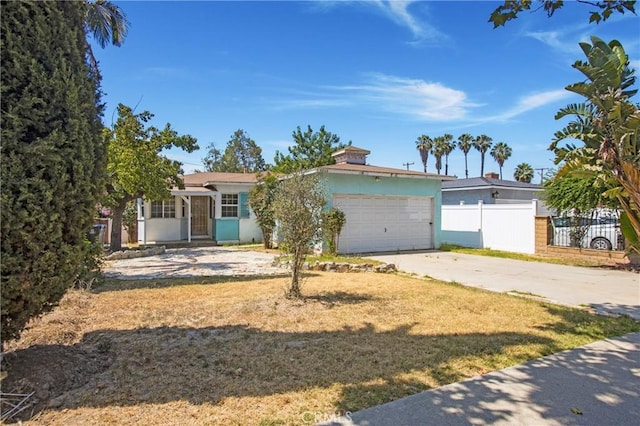 2210 W 7th St, Santa Ana, CA 92703 - view of front of house with an attached garage, driveway, and stucco siding