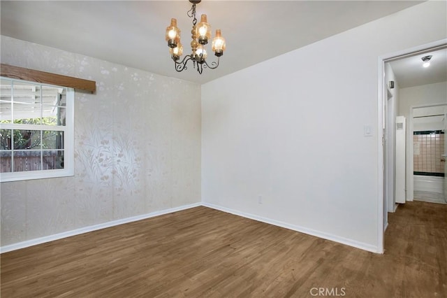 2210 W 7th St, Santa Ana, CA 92703 - empty room featuring wood finished floors and a chandelier