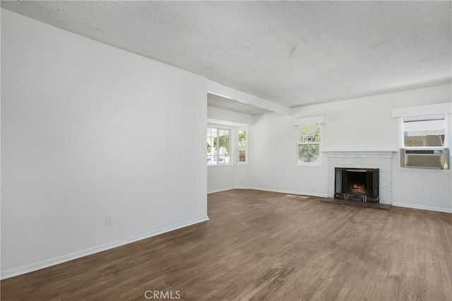 2210 W 7th St, Santa Ana, CA 92703 - unfurnished living room with cooling unit, wood finished floors, a textured ceiling, and a brick fireplace