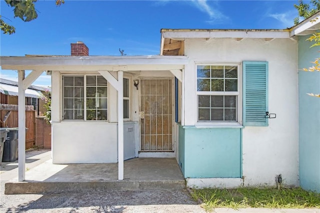 2210 W 7th St, Santa Ana, CA 92703 - doorway to property with stucco siding and a chimney