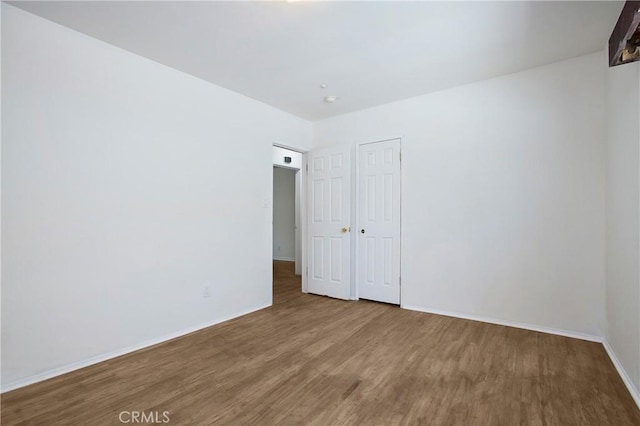 2210 W 7th St, Santa Ana, CA 92703 - empty room with wood finished floors and baseboards