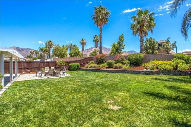 7471 Windrose Dr, Highland, CA 92346 - fenced backyard featuring a patio and a mountain view