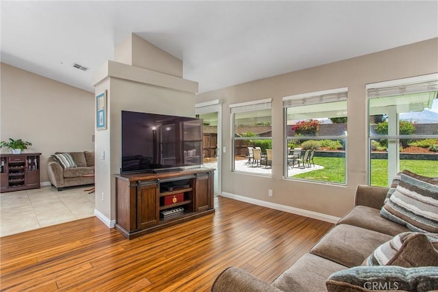 7471 Windrose Dr, Highland, CA 92346 - living room with lofted ceiling and light wood-type flooring