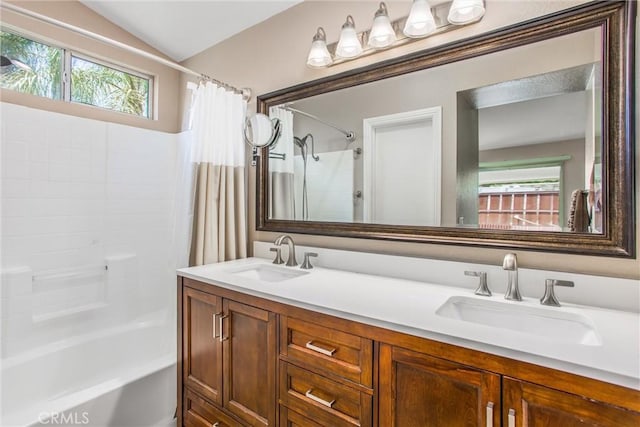 7471 Windrose Dr, Highland, CA 92346 - full bathroom with healthy amount of natural light, double vanity, shower / bath combo, and lofted ceiling